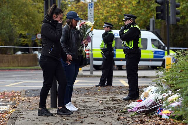 Women lay flowers near the scene of a tram crash on November 10, 2016 in Croydon, England. Seven people were killed in the disaster. Credit: Carl Court/Getty Images