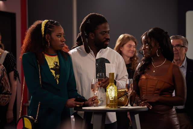 Dani Moseley as Amy, Adjani Salmon as Kwabena, and babiyre biukilwa as Vanessa in Dreaming Whilst Black, at a drinks reception (Credit: Credit: BBC/Big Deal Films/Domizia Salusest)