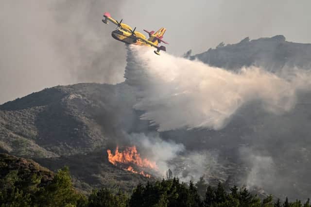 A fire fighting aircraft drops water over a wildfire close to village of Vati  in the southern part of Rhodes (Photo: Getty Images)