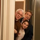 Steve Martin as Charles, Selena Gomez as Mabel, and Martin Short as Oliver in Only Murders in the Building, leaning their heads round a door (Credit: Craig Blankenhorn/Hulu)