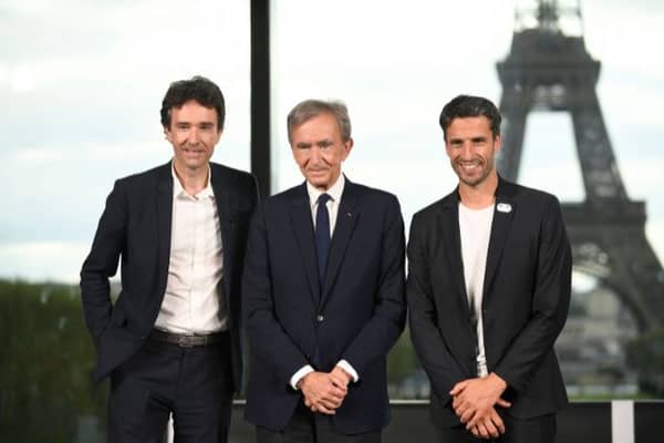 CEO of LVMH Holding Company, Antoine Arnault (L), World's top luxury group LVMH head Bernard Arnault (C) and the President of the Paris 2024 Organising Committee Tony Estanguet pose during a meeting after LVMH was named as final premium sponsor of 2024 Paris Olympics, in Paris on July 24, 2023. LVMH group announced on July 24, 2023, 
