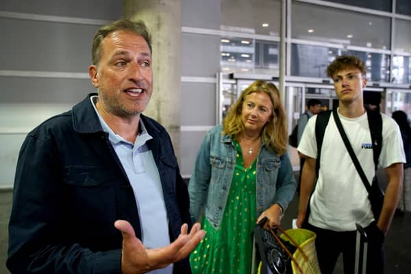 Martin (left) and Victoria Bowery with their son Hayden, arrive at Gatwick Airport after a flight from Rhodes in Greece. (Credit: Gareth Fuller/PA Wire)