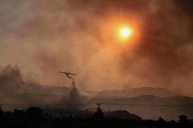 A Canadair firefighting airplane sprays water on a fire in Gennadi, on the southern part of Rhodes (Photo: Getty Images)