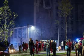 Rescuers stand outside a residential building partially destroyed after missiles strike in Dnipro on July 28, 2023 (Photo by VITALII MATOKHA/AFP via Getty Images)
