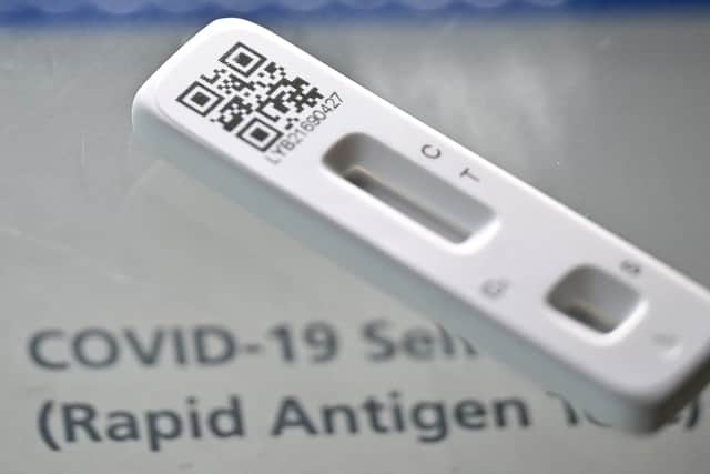 A picture taken on February 20, 2022 shows a Covid-19 Lateral Flow (LFT) self-test kit, containing a SARS-CoV-2 Antigen Rapid Test, arranged for a photograph, in London (Photo by JUSTIN TALLIS/AFP via Getty Images)
