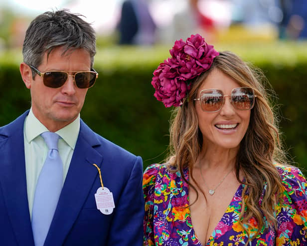 CHICHESTER, ENGLAND - JULY 27: Actress Liz Hurley with friend Henry Birtles during day two of the Qatar Goodwood Festival at Goodwood Racecourse on July 27, 2022 in Chichester, England. (Photo by Alan Crowhurst/Getty Images)