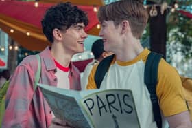 Joe Locke as Charlie Spring and Kit Connor as Nick Nelson in Heartstopper Season 2, holding a tour guide to Paris (Credit: Teddy Cavendish/Netflix)