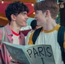 Joe Locke as Charlie Spring and Kit Connor as Nick Nelson in Heartstopper Season 2, holding a tour guide to Paris (Credit: Teddy Cavendish/Netflix)