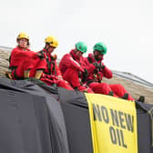 Greenpeace activists on the roof of Prime Minister Rishi Sunak's house in Richmond, North Yorkshire after covering it in black fabric in protest at his backing for expansion of North Sea oil and gas drilling (Photo: Danny Lawson/PA Wire)