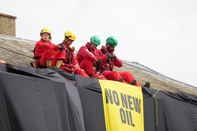 Greenpeace activists on the roof of Prime Minister Rishi Sunak's house in Richmond, North Yorkshire after covering it in black fabric in protest at his backing for expansion of North Sea oil and gas drilling (Photo: Danny Lawson/PA Wire)