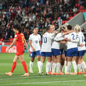 England Lionesses celebrate their first goal against China in Group D match