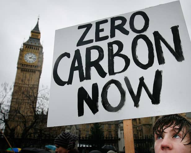 A climate change protestor walks near Parliament on December 8, 2007 in London. (Photo by Peter Macdiarmid/Getty Images)