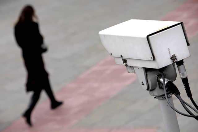 A CCTV camera observes a woman walking in the Embankment area of central London in 2007 (Photo: Leon Neal/AFP via Getty Images)