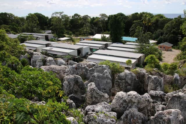 A cluster of corrugated iron huts resembling military barracks jut out of Nauru's sweltering rocky landscape to reveal refugee settlement camp number five, a place defined by desperation and rarely visited by outsiders. (Photo credit should read MIKE LEYRAL/AFP via Getty Images)
