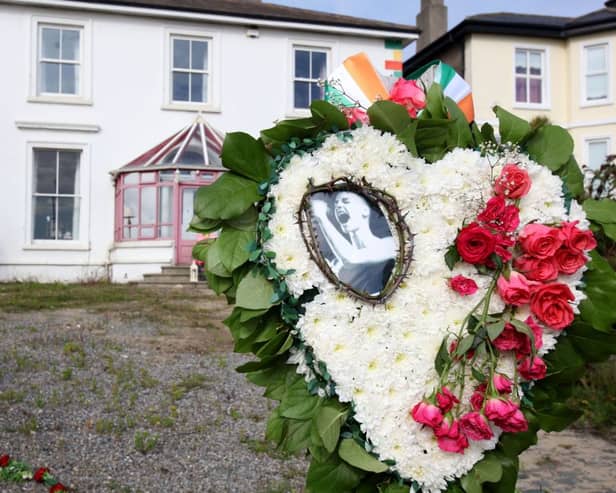 Flowers and tributes are pictured outside the former home of Irish singer Sinead O'Connor, in Bray, eastern Ireland, ahead of her funeral. A funeral service for Sinead O'Connor, the outspoken singer who rose to international fame in the 1990s, is to be held on Tuesday in the Irish seaside town of Bray. (Photo by PAUL FAITH / AFP) (Photo by PAUL FAITH/AFP via Getty Images)