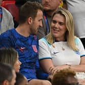 OPSHOT - England's forward Harry Kane talks with his wife Katie Goodland after defeating Wales 3-0 in the Qatar 2022 World Cup Group B football match between Wales and England at the Ahmad Bin Ali Stadium in Al-Rayyan, west of Doha on November 29, 2022. (Photo by Paul ELLIS / AFP) (Photo by PAUL ELLIS/AFP via Getty Images)