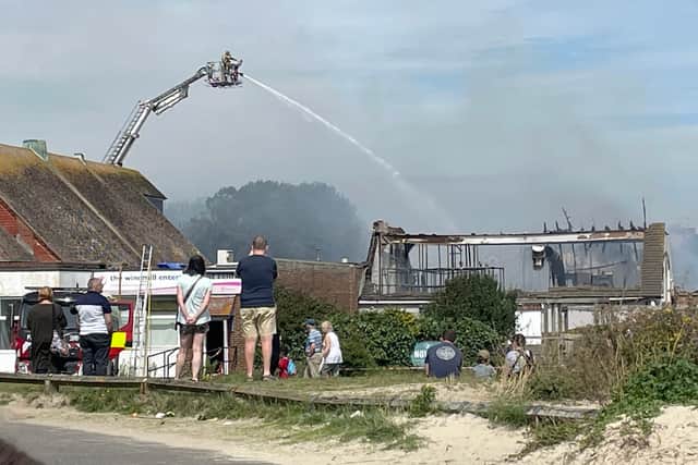 Handout photo by Danielle Mason of firefighters tackling a blaze at a Harvester restaurant in Littlehampton, West Sussex, which has produced large plumes of smoke visible for miles around and destroyed the establishment's roof. (Image PA)