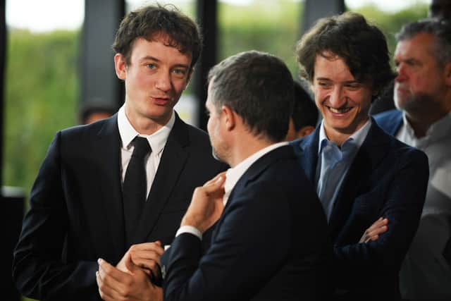 Bernard Arnault's sons Frederic Arnault (L) and Jean Arnault (R) react as they attend a meeting after LVMH was named as final premium sponsor of 2024 Paris Olympics, in Paris on July 24, 2023. (Photo by JULIEN DE ROSA/AFP via Getty Images)
