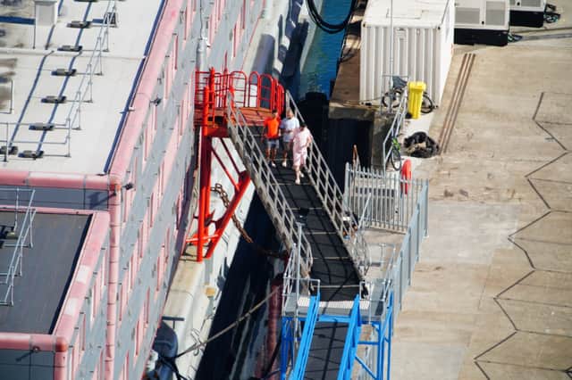 People thought to be asylum seekers arrive to board the Bibby Stockholm accommodation barge at Portland Port in Dorset, which will house up to 500 people. Picture date: Wednesday August 9, 2023. Credit: Ben Birchall/PA Wire