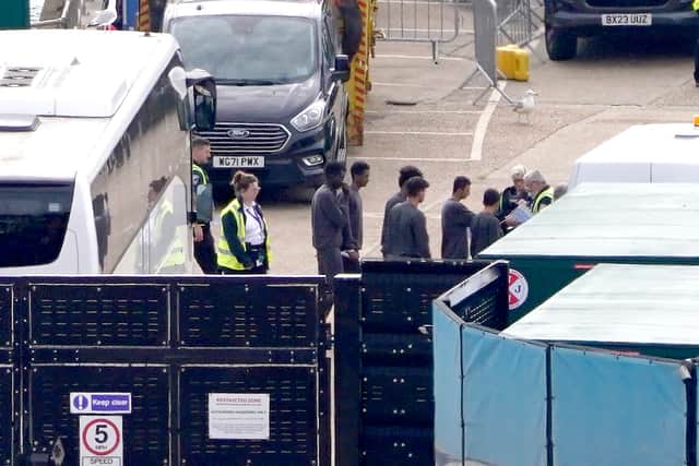 A group of migrants who arrived in the UK earlier this week are transported from the migrant reception compound in Dover, Kent. Credit: Gareth Fuller/PA Wire