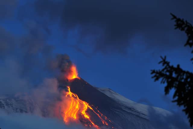 Lava flows from the Mount Etna volcano on the southern Italian island of Sicily near Catania early on December 16, 2013.