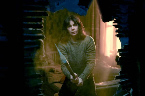 Ruth Wilson as Lorna Brady in The Woman in the Wall, holding an axe (Credit: BBC/Motive Pictures/Chris Barr)