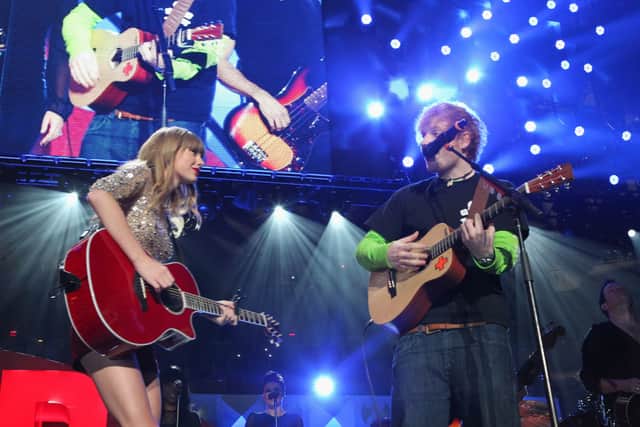 Taylor Swift performs onstage during Z100's Jingle Ball 2012, with Ed Sheeran (Photo by Kevin Kane/Getty Images for Jingle Ball 2012)