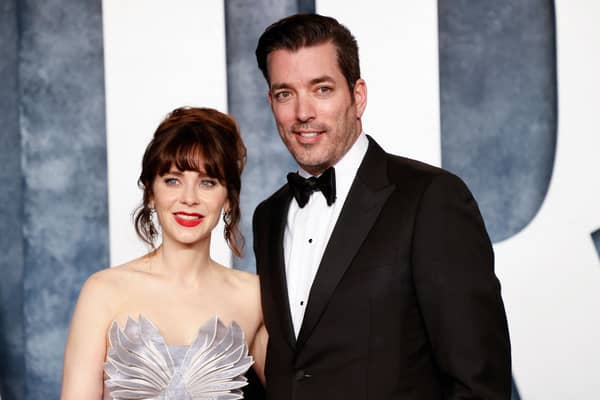 US actress Zooey Deschanel and Canadian television personality Jonathan Scott attend the Vanity Fair 95th Oscars Party at the The Wallis Annenberg Center for the Performing Arts in Beverly Hills, California on March 12, 2023. (Photo by Michael TRAN / AFP) (Photo by MICHAEL TRAN/AFP via Getty Images)