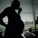A pregnant woman at an office desk. Picture: Daniel Berehulak / Getty Images