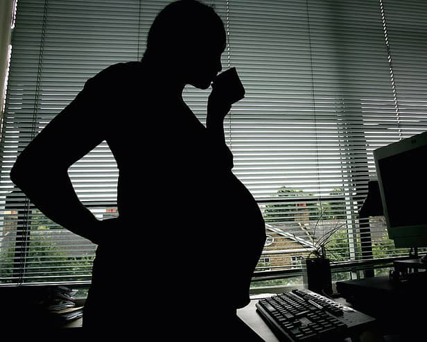 A pregnant woman at an office desk. Picture: Daniel Berehulak / Getty Images