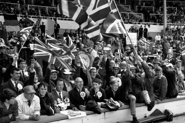 Some of the England fans wave their Union Jack flags at Wembley Stadium, London, for the 1966 World Cup Final against West Germany, which England won 4-2. (Photo by A. Jones/Evening Standard/Getty Images)