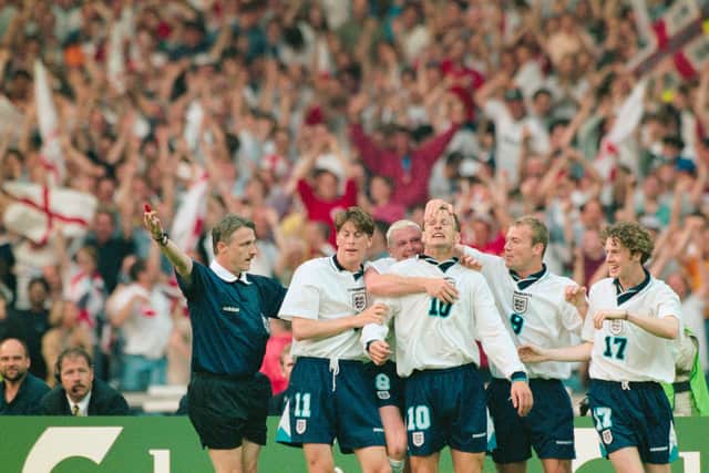 England players Darren Anderton (l) Paul Gascoigne (2nd l)  celebrate with goalscorer Teddy Sheringham (c) and Alan Shearer and Steve McManaman (r) after he had scored the second goal during the 1996 European Championships group match against Holland at Wembley Stadium on June 18, 1996 in London, England. Notice the St george's flags in the background