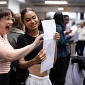 Student Maya Adams (R) of The City of London Academy in Southwark opens her A-Level results with her drama teacher Ms Young on August 18, 2022 in London. Photo for illustrative purposes.