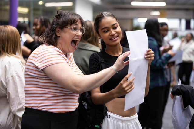 Student Maya Adams (R) of The City of London Academy in Southwark opens her A-Level results with her drama teacher Ms Young on August 18, 2022 in London. Photo for illustrative purposes.