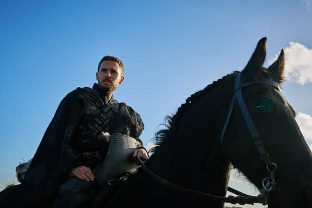 Iain De Caestecker as Arthur Pendragon in The Winter King, riding on horseback (Credit: ITVX)