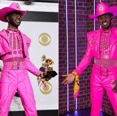 Lil Nas X's waxwork (R) is based on the outfit the musician wore at the 2020 Grammy Awards (credit: Getty Images/Merlin Entertainment)