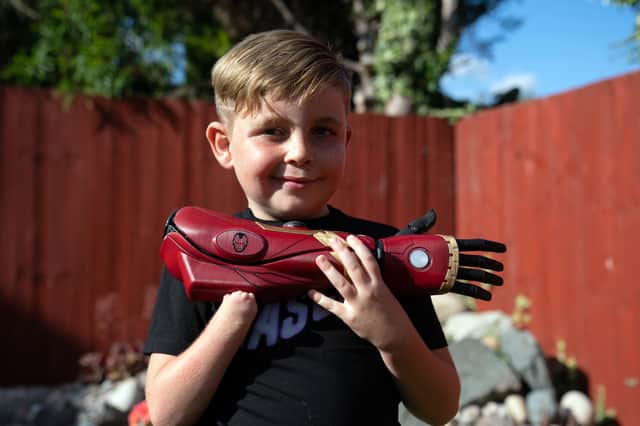 Louie Morgan-Kemp, seven, who was born without a right hand, demonstrates his new prosthetic arm called a Hero Arm, made by Bristol-based Open Bionics. (Picture: PA)