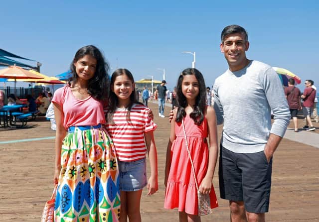 Prime Minister Rishi Sunak, with his wife Akshata Murty and children Krishna (2L) and Anoushka (2R), pose for a photograph whilst on holiday, at Santa Monica Pier. Credit: EMMA MCINTYRE/POOL/AFP via Getty Images