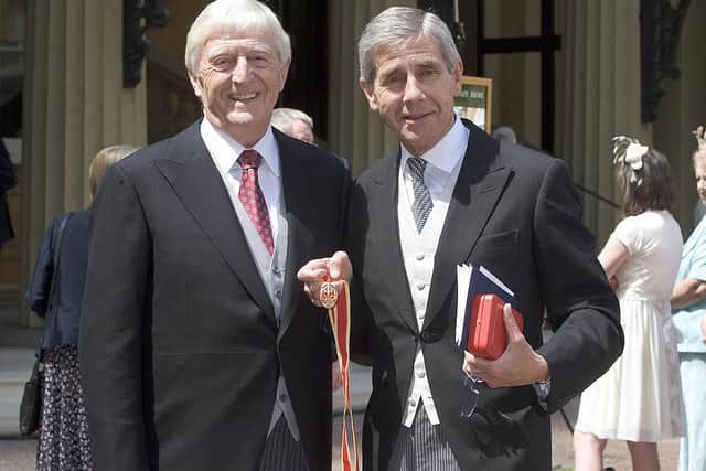 The late Sir Michael Parkinson (L) and Chief Executive of Marks & Spencer Sir Stuart Rose pose for photographs after receiving their Honour of Knighthood from Britain’s Queen Elizabeth II at Buckingham Palace, in London, on June 4, 2008.(JENNY GOODALL/AFP via Getty Images)