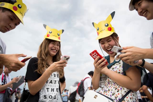 People play Nintendo Co.'s Pokemon Go augmented reality game on their smartphones during the Pikachu Outbreak event hosted by The Pokemon Co. on August 9, 2017 in Yokohama, Kanagawa, Japan (Photo by Tomohiro Ohsumi/Getty Images)