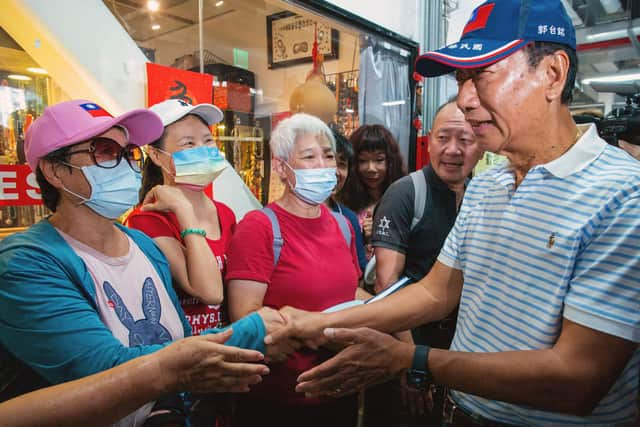 Taiwan's independent presidential candidate and Foxconn founder Terry Gou (R) greets supporters while campaigning at a traditional market in Taipei on August 11, 2023. (Photo by SAM YEH/AFP via Getty Images)