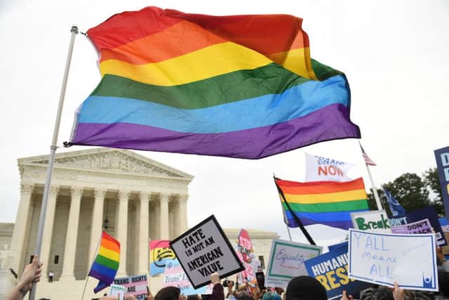 Demonstrators in favour of LGBTQ+ rights rally outside the US Supreme Court in Washington, DC, October 8, 2019, as the court holds oral arguments in three cases dealing with workplace discrimination based on sexual orientation. (Photo by SAUL LOEB / AFP) (Photo by SAUL LOEB/AFP via Getty Images)