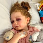 Lily-Mae West, age 8, broke 15 bones in her skull and suffered a brain injury after getting hit by a zorbing ball. She is pictured in hospital after the accident. Photo by Day One Trauma Support/SWNS.