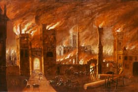 Framed, oil on canvas painiting of the Great Fire of London, seen from outside Newgate. People are shown running through the gateway, some of them carrying bundles of belongings. A woman sits on the ground next to a baby in a cradle. St Paul's cathedral can be seen in the background. (credit: Museum of London)