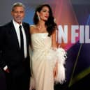 US actor George Clooney and his wife Lebanese-British barrister Amal Clooney pose on the red carpet on arrival to attend the UK premiere of the film 'The Temple Bar', during the 2021 BFI London Film Festival in London on October 10, 2021. (Photo by Niklas HALLE'N / AFP) (Photo by NIKLAS HALLE'N/AFP via Getty Images)