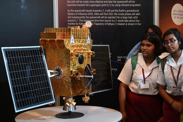 Students look at a model of Aditya-L1 spacecraft ahead of its launch, in a science and technology museum in Kolkata on September 2, 2023. (Image: DIBYANGSHU SARKAR/AFP via Getty Images)