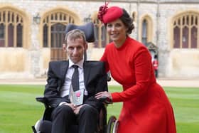 Former rugby league player Rob Burrow and his wife Lindsey pose for a photograph with his medal after Rob is appointed a Member of the Order of the British Empire (MBE) at an investiture ceremony at Windsor Castle, on April 5, 2022. (Photo by Steve Parsons / POOL / AFP) (Photo by STEVE PARSONS/POOL/AFP via Getty Images)