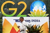 A pedestrian walks past a G20 summit logo installed along a street in New Delhi 6 September 6 2023 (Photo: SAJJAD HUSSAIN/AFP via Getty Images)