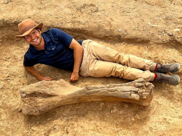 Dr Juliën Lubeek next to a nearly complete upper arm bone of the extinct giant elephant Palaeoloxodon recki in the desert near Lake Turkana in Kenya. (SWNS)