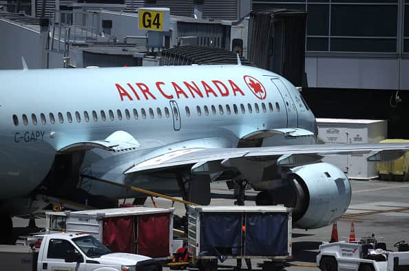 Air Canada has issued an apology after two passengers were kicked off the plane over vomit-covered seats.